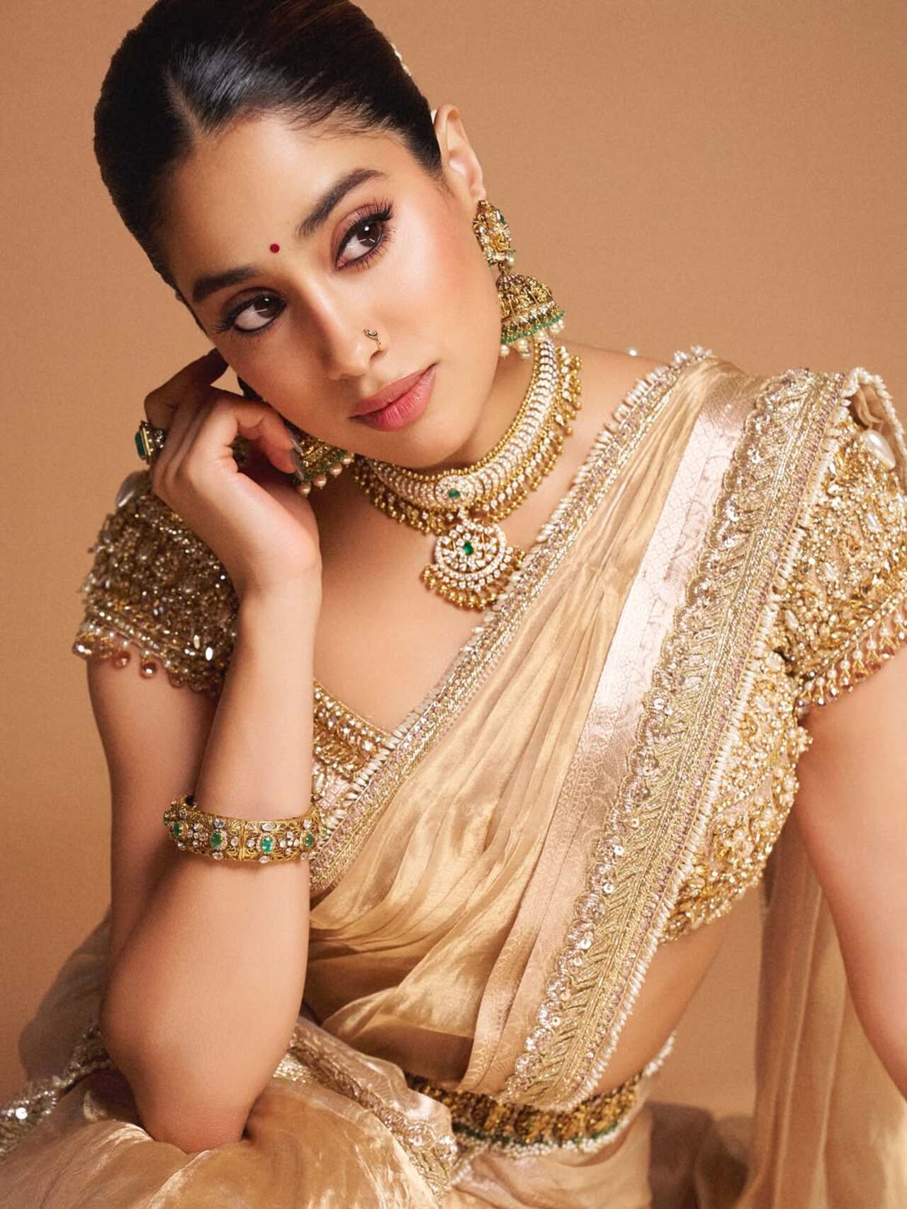 Janhvi channels royal glamour in a golden embellished half saree, complete with statement jewelry. This opulent look is perfect for festive evenings and grand Onam feasts